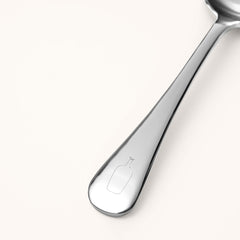 Cupping spoon handle etched with the Blue Bottle logo.