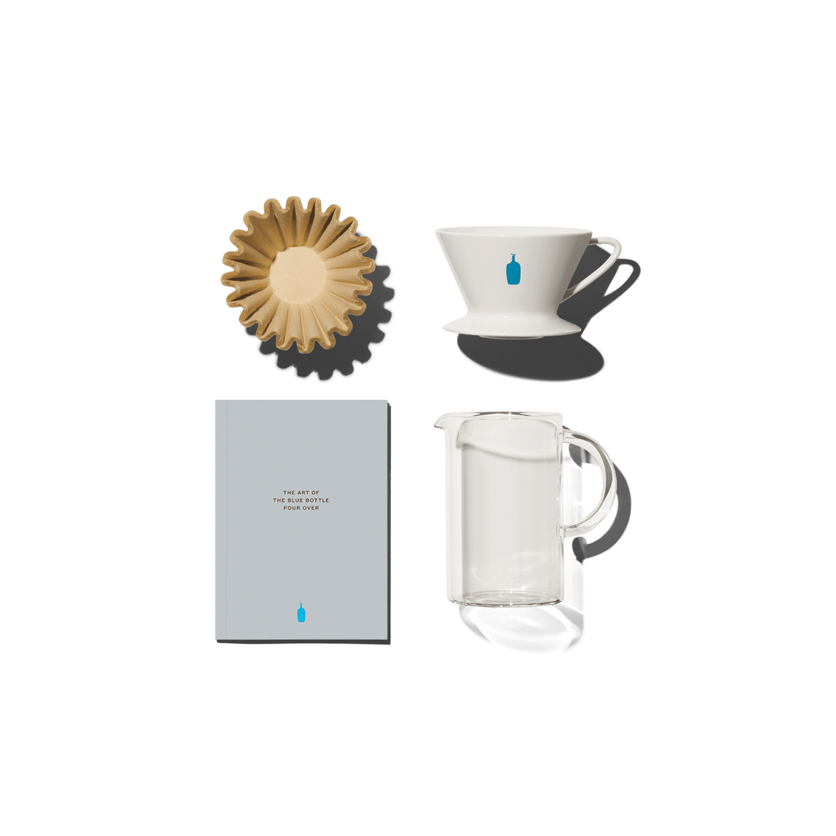 A stack of filters, blue bottle dripper, instructional booklet, and carafe.