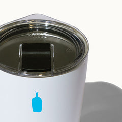 Detailed view of the clear lid and blue bottle logo.